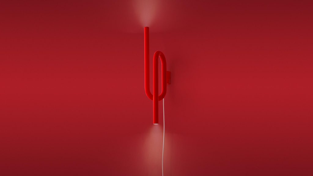 wall lamp emits symmetrical light in a red tone on a red background