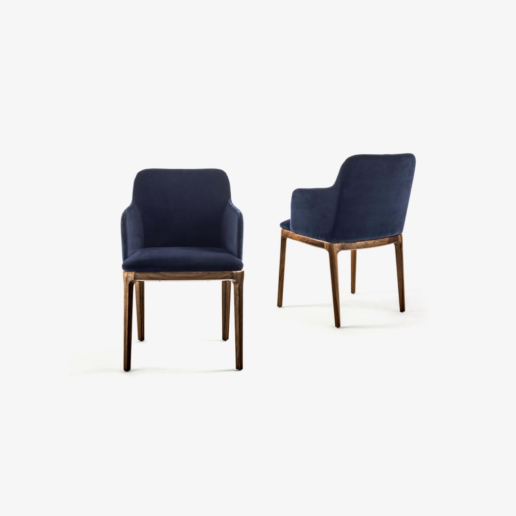 two elegant chairs with armrests made with solid wood legs upholstered in smooth fabric in a dark blue tone