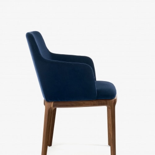 elegant chair with armrests made with solid wood legs upholstered in smooth fabric in a dark blue tone