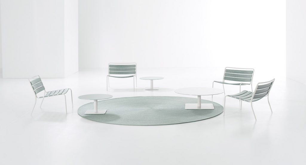 four armchairs made with a white steel base and headband strips in a light blue tone on a white background