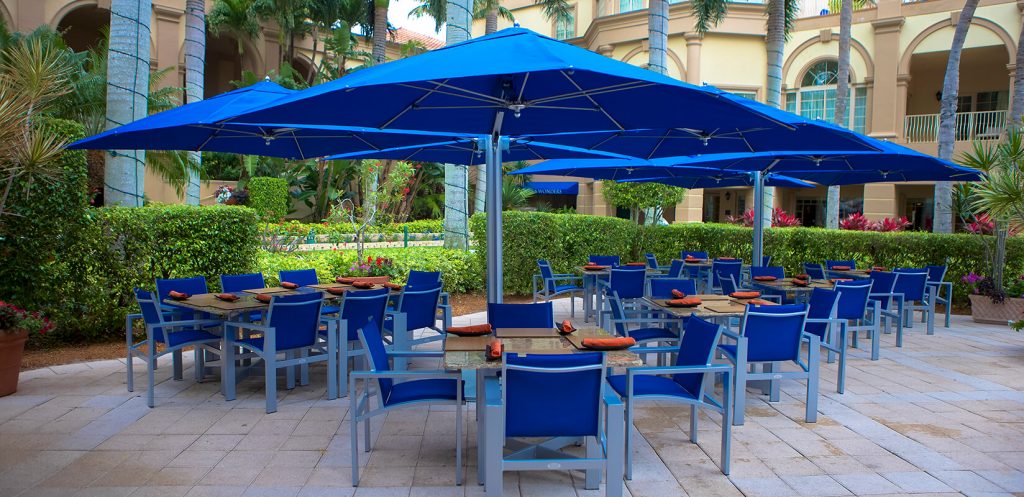 four large parasol made of a wooden base and made of fabric in a tone of royal blue