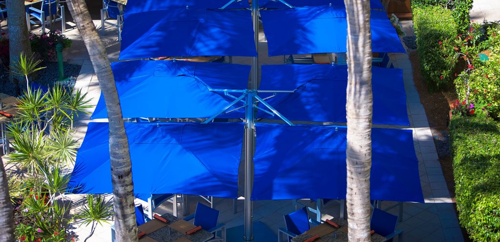 large parasol made of a wooden base and made of fabric in a tone of royal blue