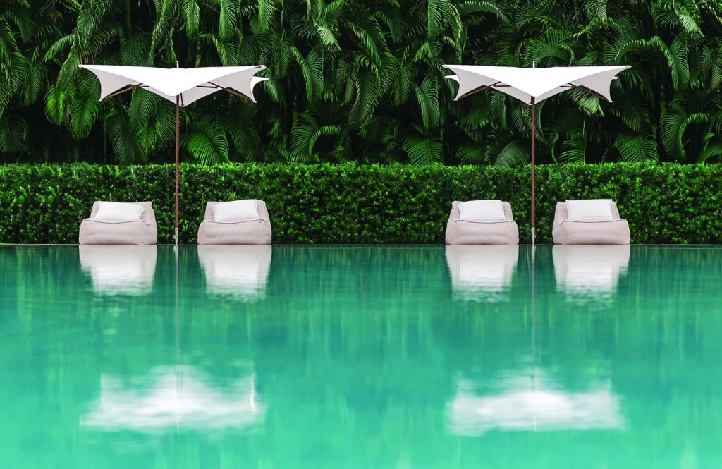 Two parasol with polished titanium structure in the middle and fabric on the top in white color tone