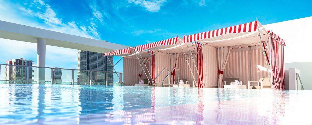 two living room pavilion made with fabric walls and two beach chairs in a red and white color tone