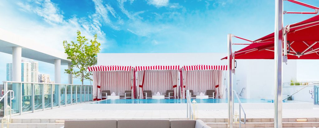 three living room pavilion made with fabric walls and two beach chairs in a blue and white color tone