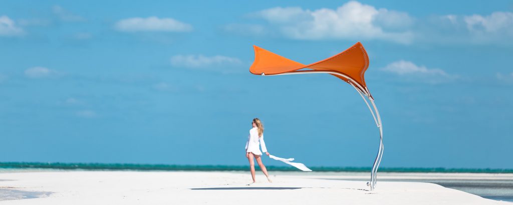 parasol made on the basis of a wing in a combination of marine elements and materials in a orange tone on a peach background