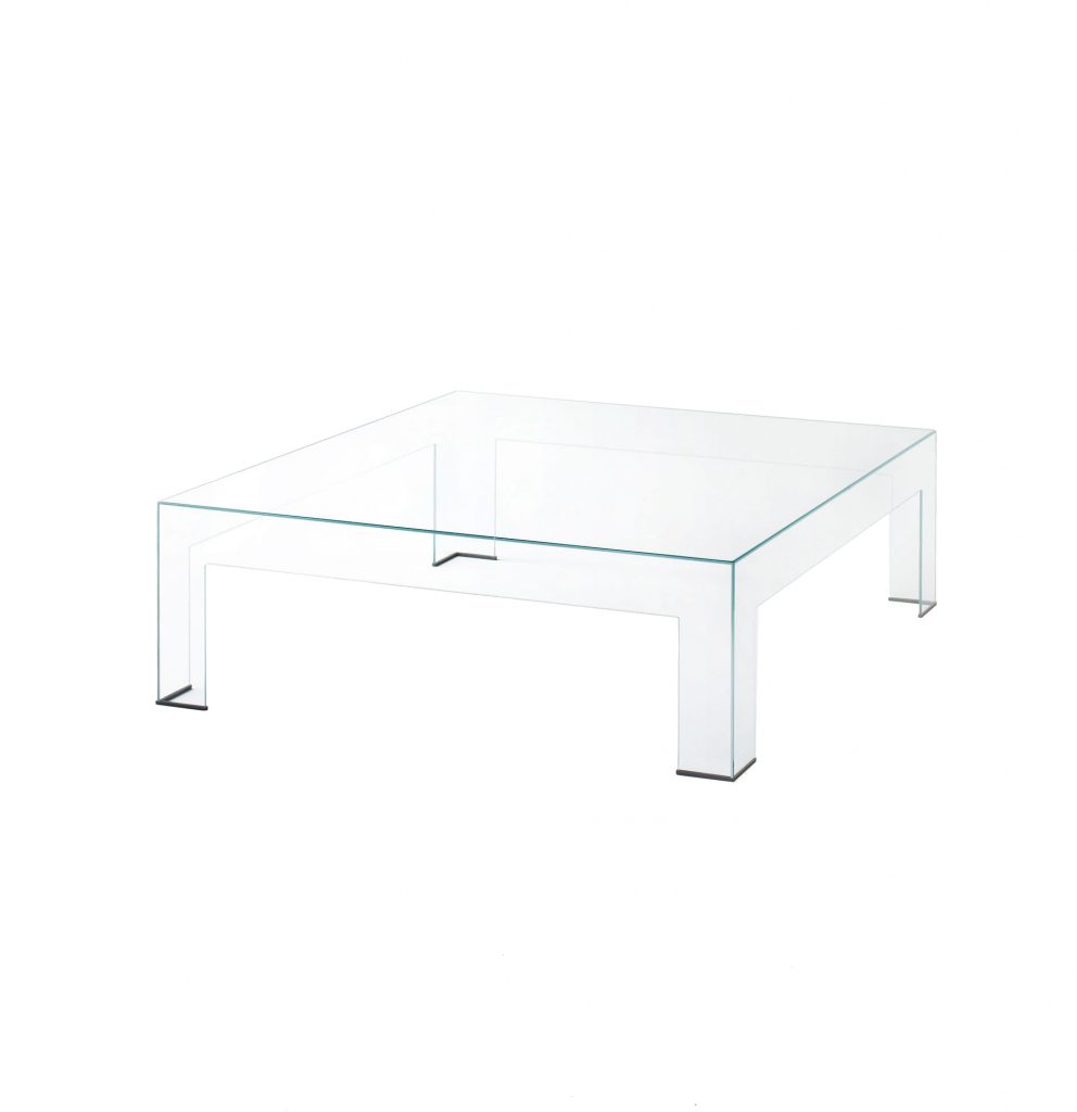 low table composed of transparent tempered glass plates on a white background