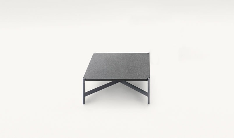 auxiliary table made on a metal structure finished in a dark gray tone on a black natural stone top