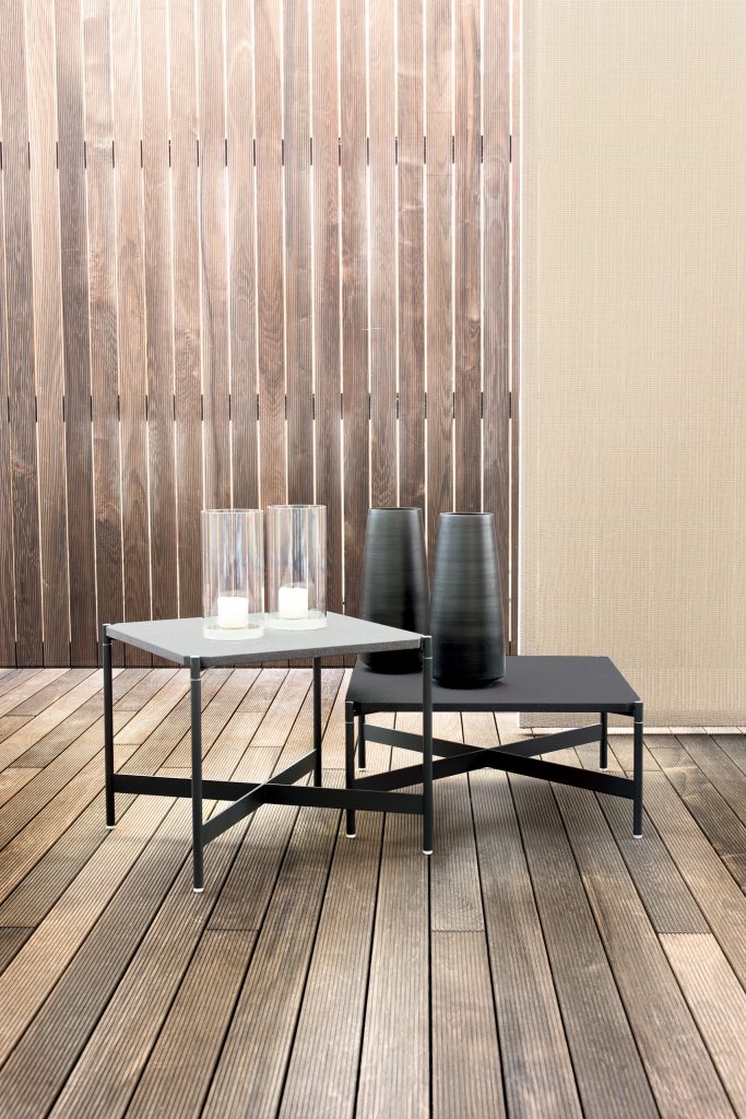 two side tables made of metal base with a black and gray stone top in a room