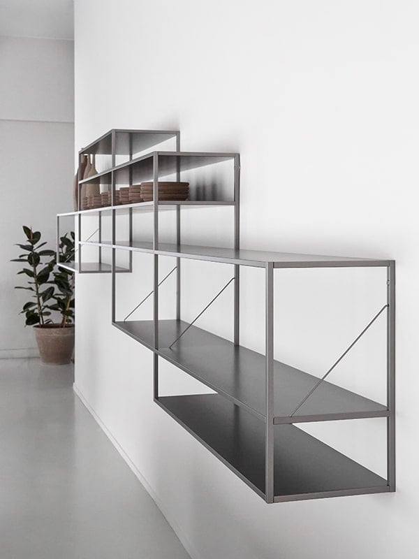 several levels of shelves made of aluminum in a silver tone in the shape of squares