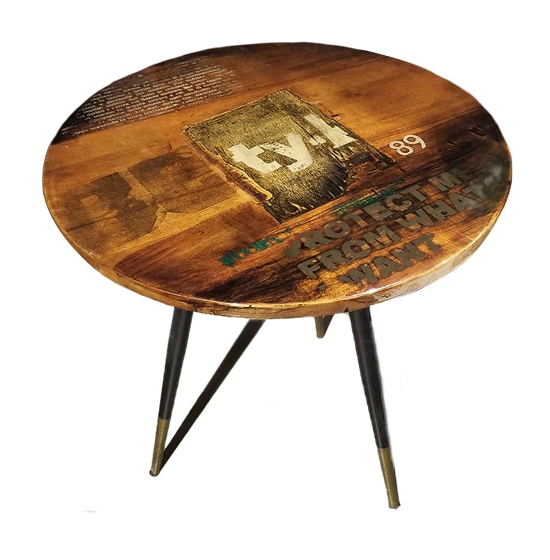 round side table made of silk-screened wood with the top finished in resin on a white background