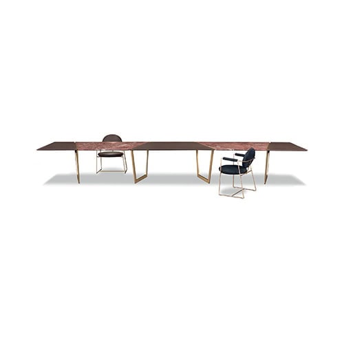 large dining table made of satin brass base on the top made of red 