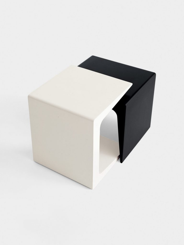 two C-shaped coffee table made of lacquered wood base in a tone of withe and black tone
