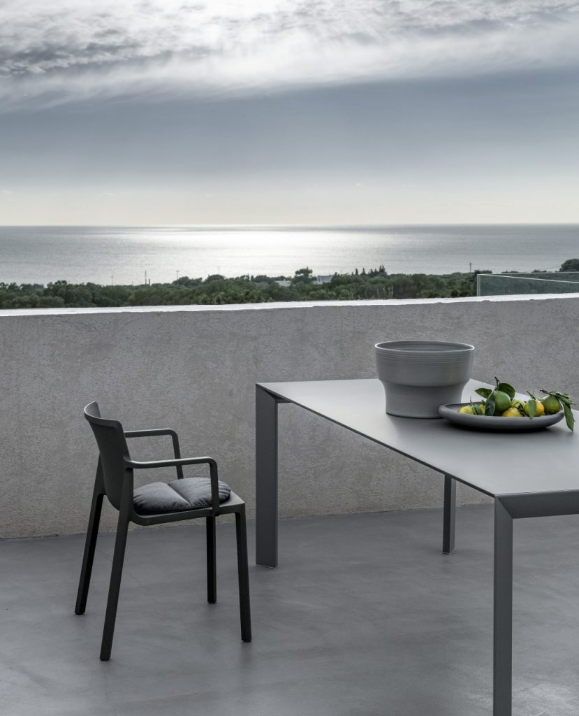 chairs made of molded polypropylene and removable cushions in a tone of gray and dark gray
