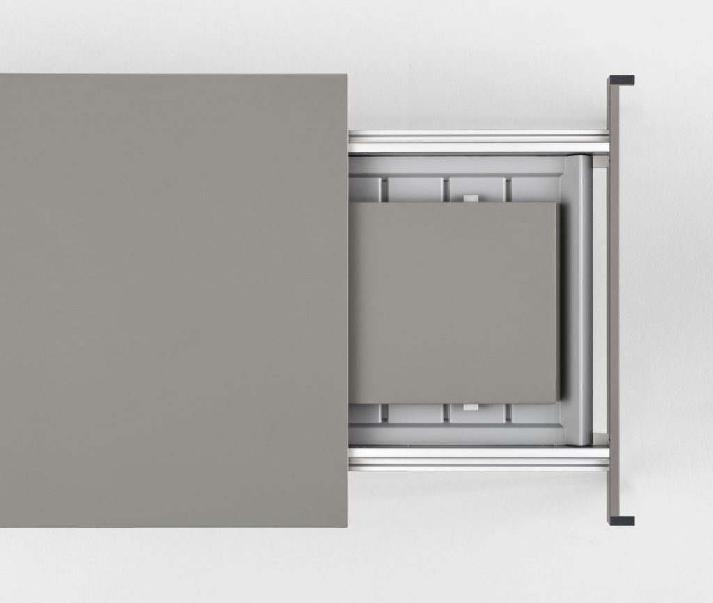 extendable table made of wood and aluminum in its structure in a light gray tone