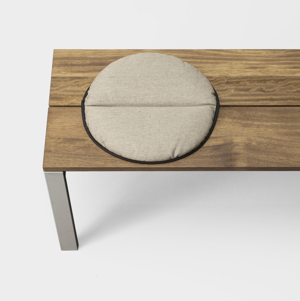 stool made of steel base and wooden tops with cushion implemented in a brown and gray tone