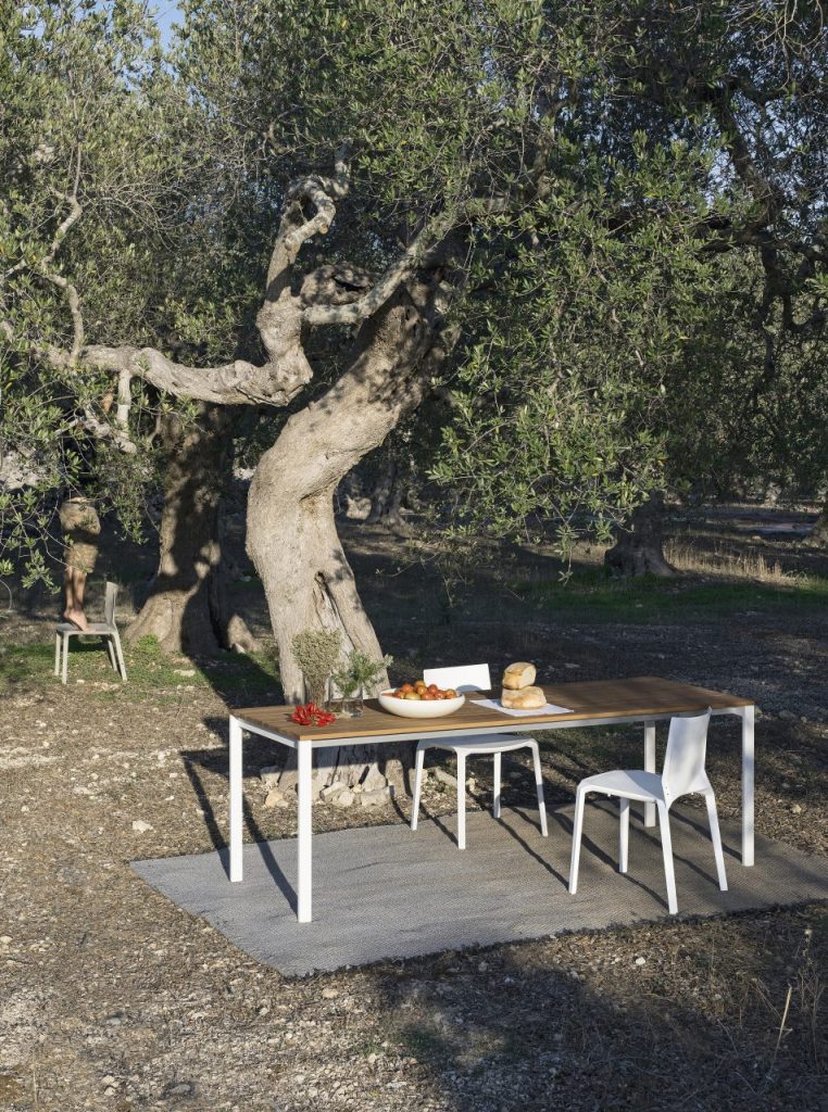 dining table made of wooden planks and steel base in a white with coffee color tone