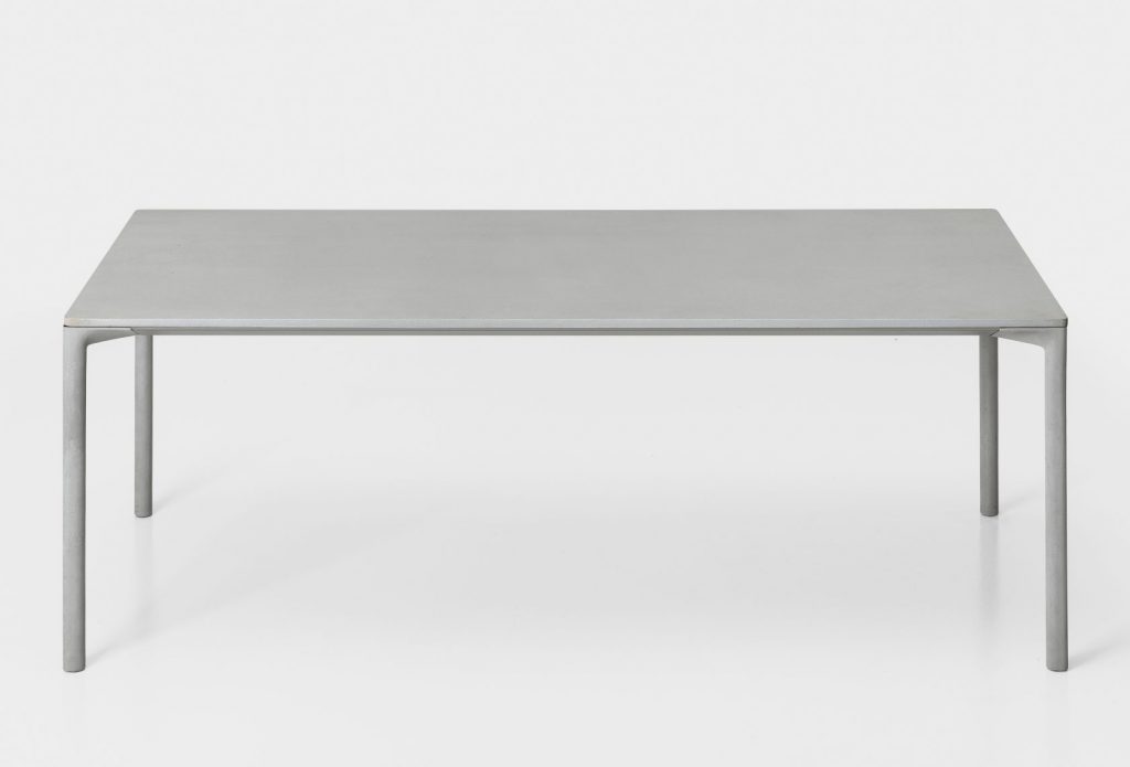 long table made of wooden legs and cement top in gray tone on white background