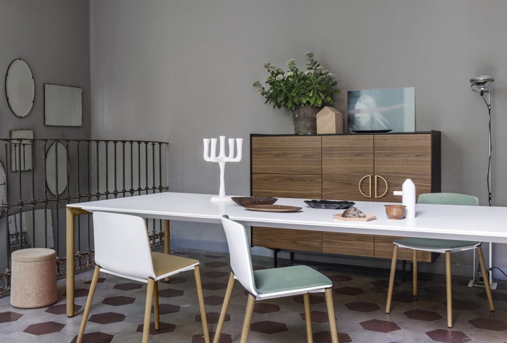 dining table made of white cement and brown wooden legs