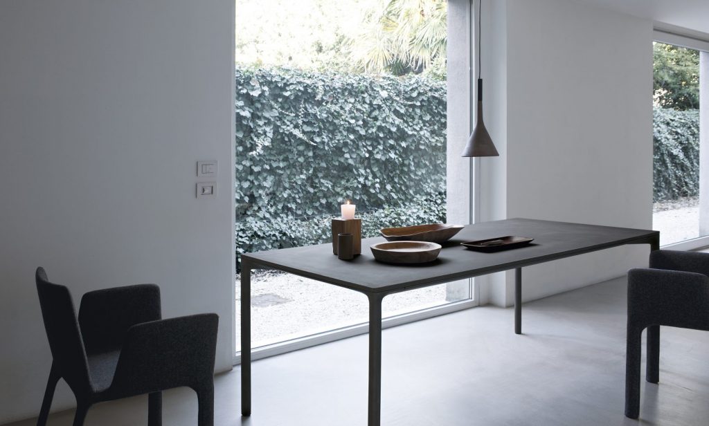 dining table made of gray cement and wooden legs