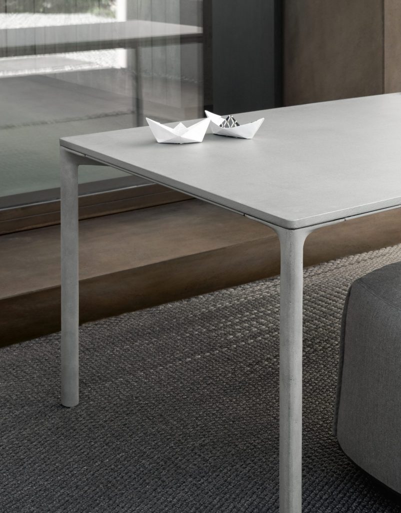 table made of polished cement base in a white tone on wooden legs