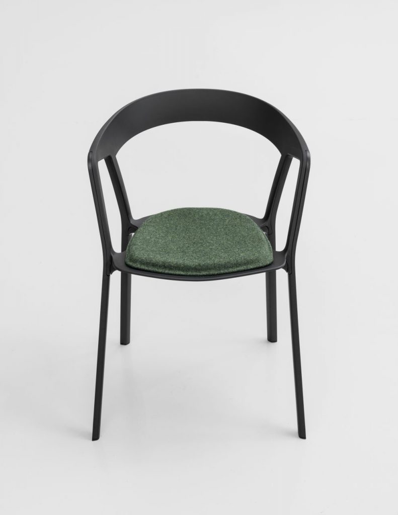 chair made of plastic with fabric cushion in a tone of black with green