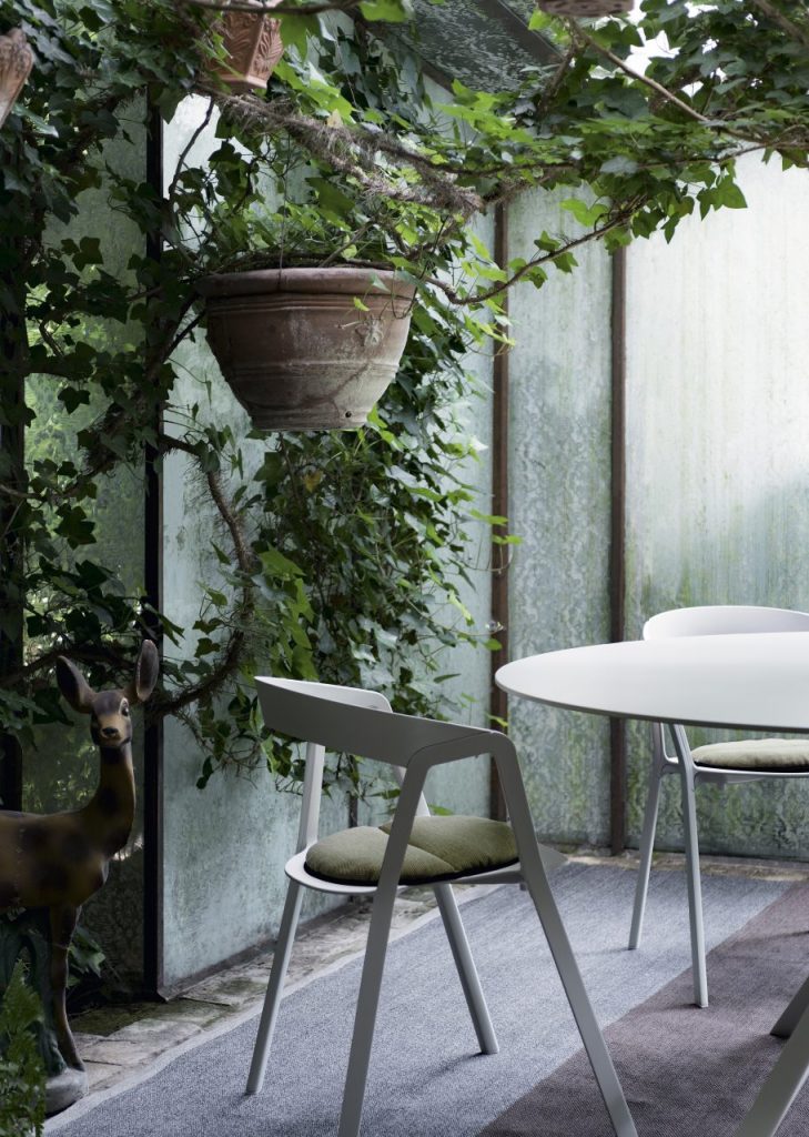 chair made of plastic in a white tone with light green fabric cushion