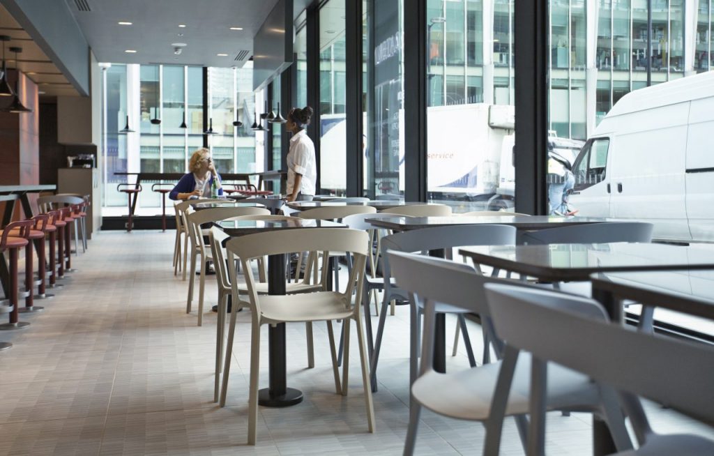 line of chairs with openings in their design made of plastic in a yellow and white tone
