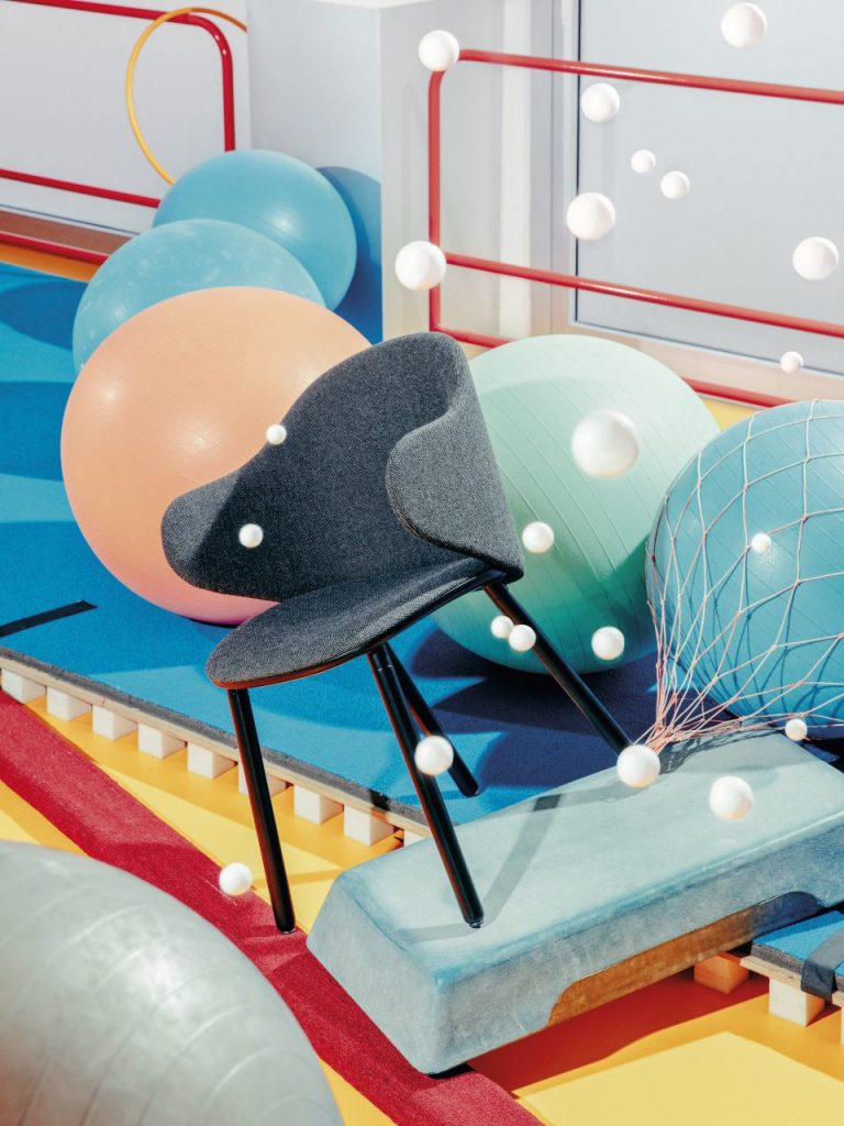 chair made from wooden legs upholstered in blue fabric with armrests
