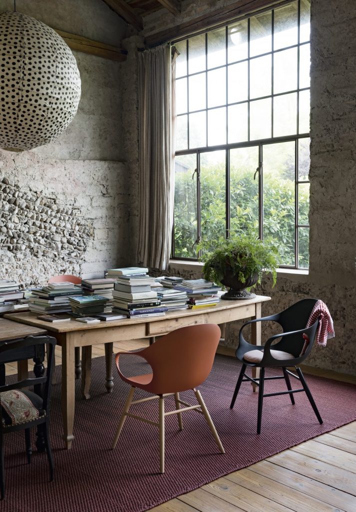 two chairs made of wooden legs and polyurethane in an orange and black tone