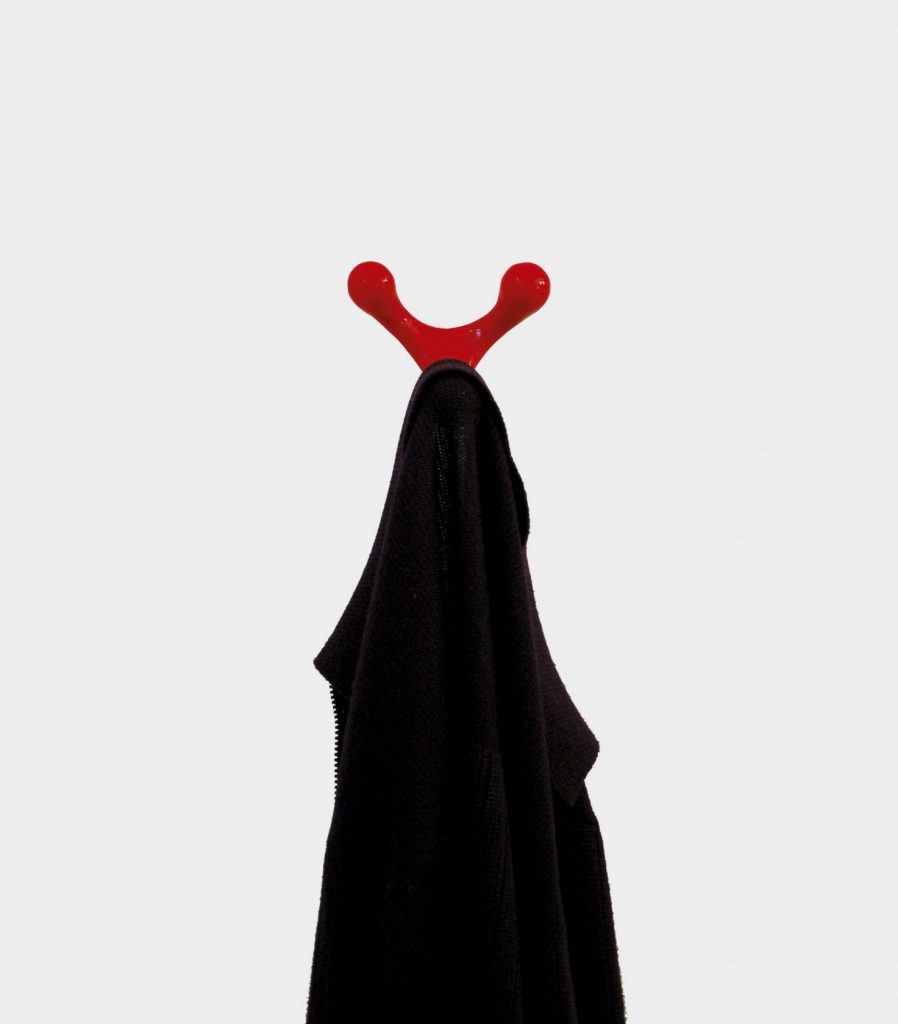 coat rack in a red tone made with a cast aluminum base in the shape of reindeer antlers