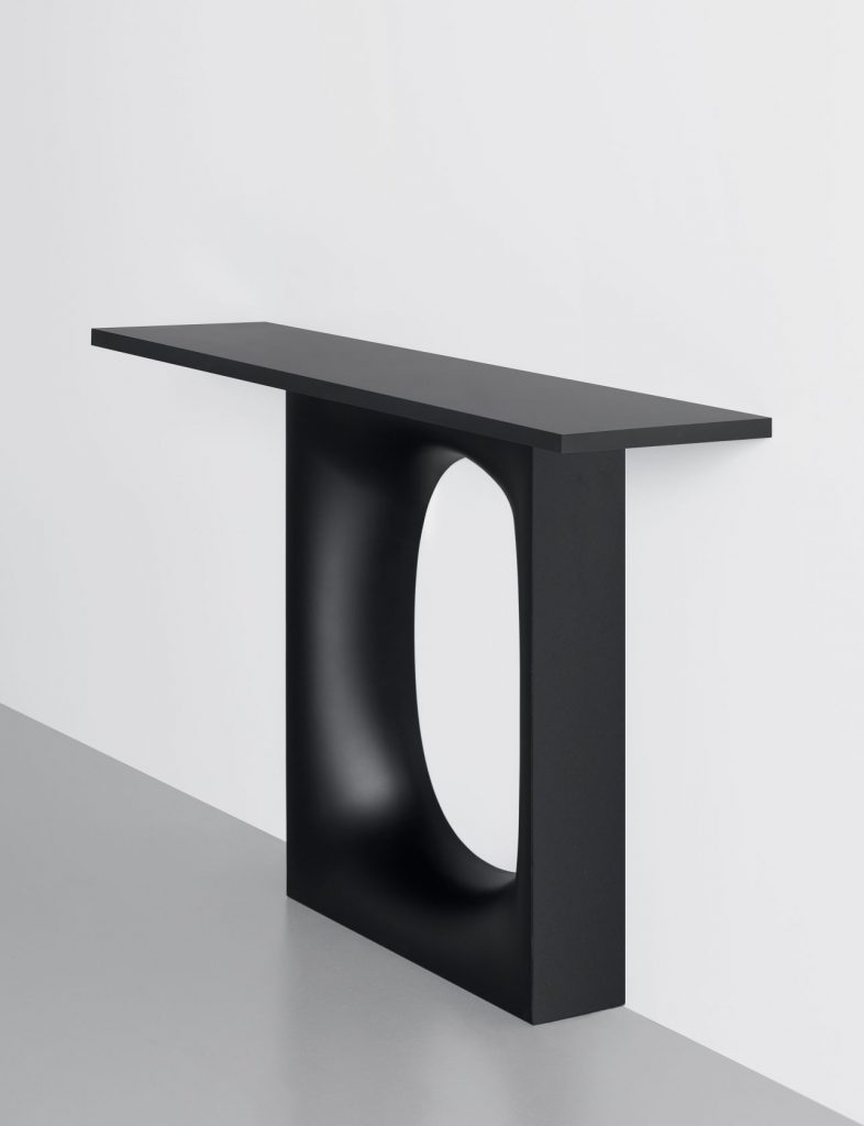 high table made of wooden base in a black color tone with a hole in the middle
