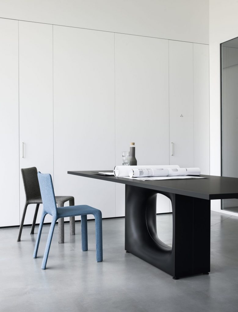 large table made of black wood base with a hole in the middle in a black color tone