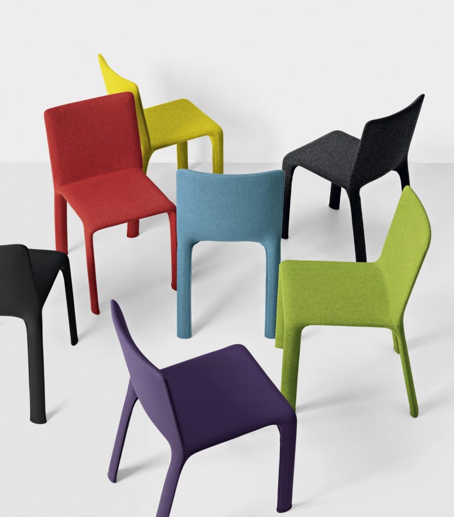 seven chairs made of aluminum and upholstered in fabric in shades of blue, red, yellow, green, purple and black
