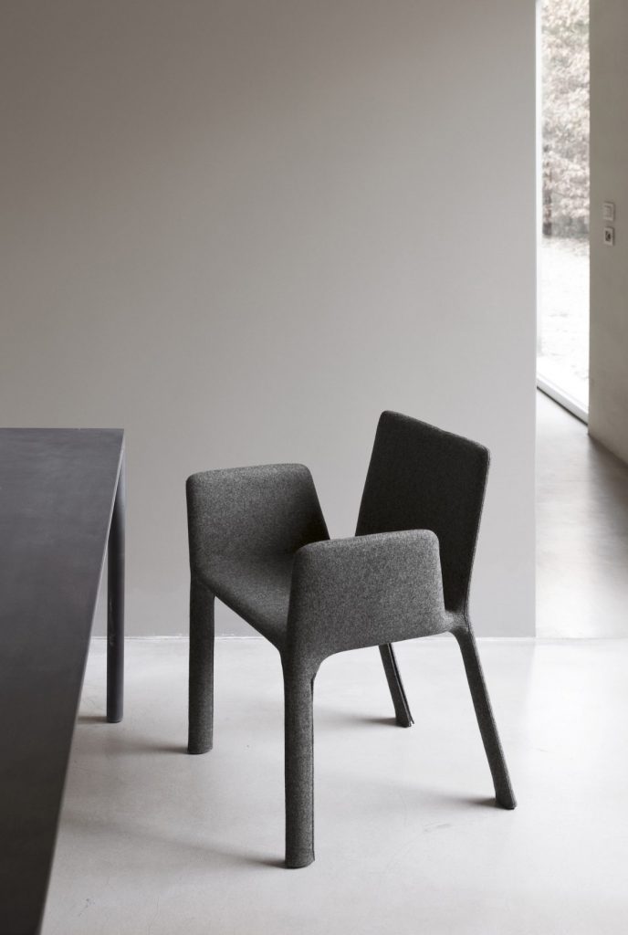 chair made of gray fabric with armrests on a white background