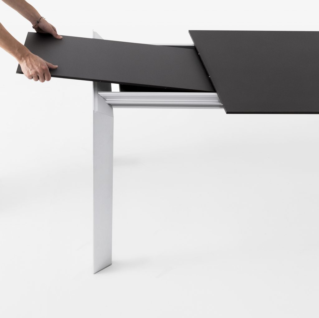 extendable table made of metal and aluminum in a black and gray tone on a white background