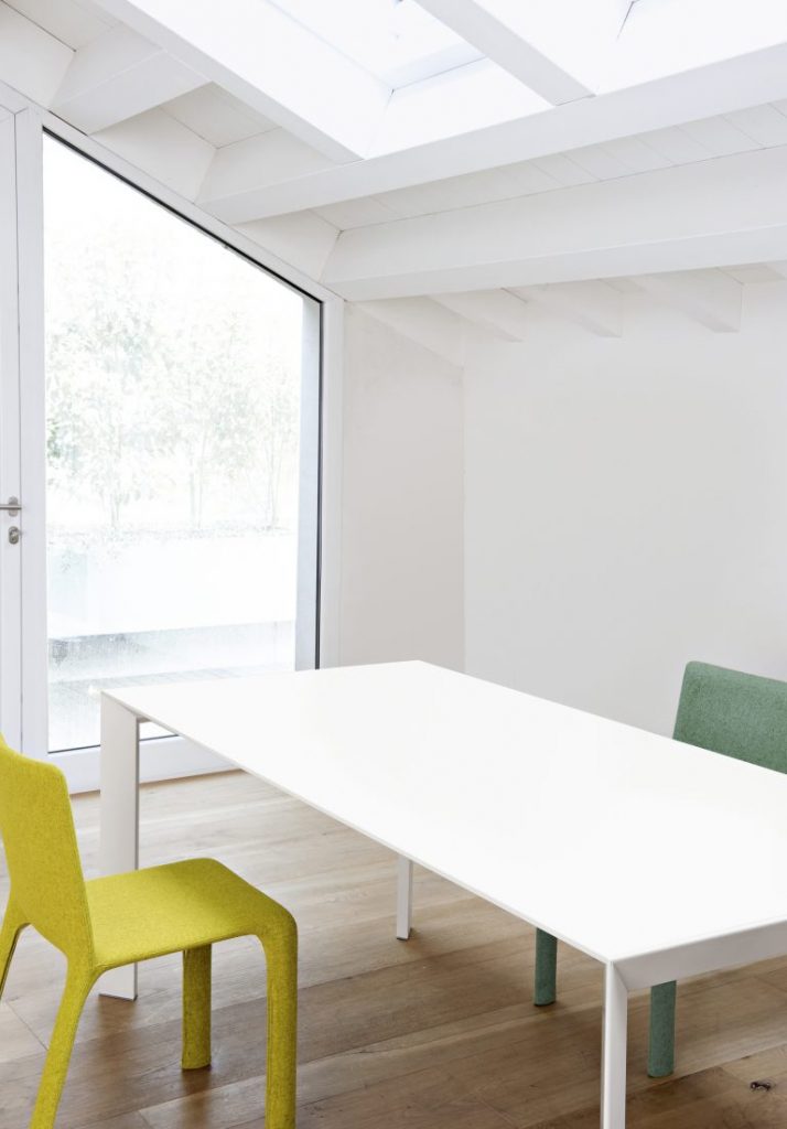 Rectangle-shaped table made of wooden base and steel legs in a white tone