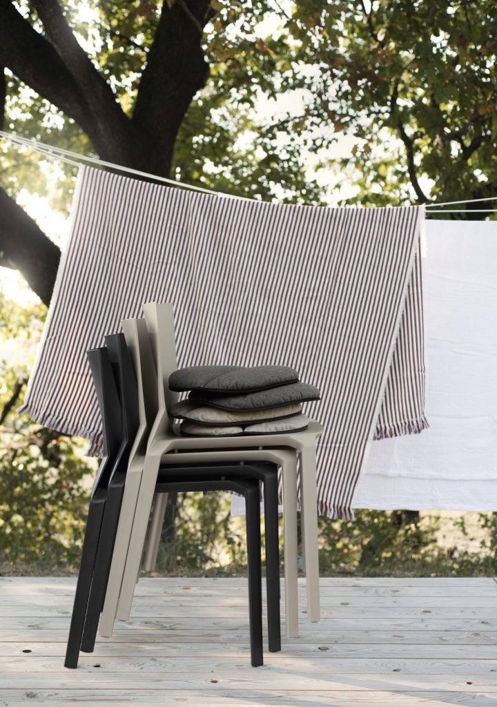 three chairs one on top of the other made of polypropylene in black and beige tones