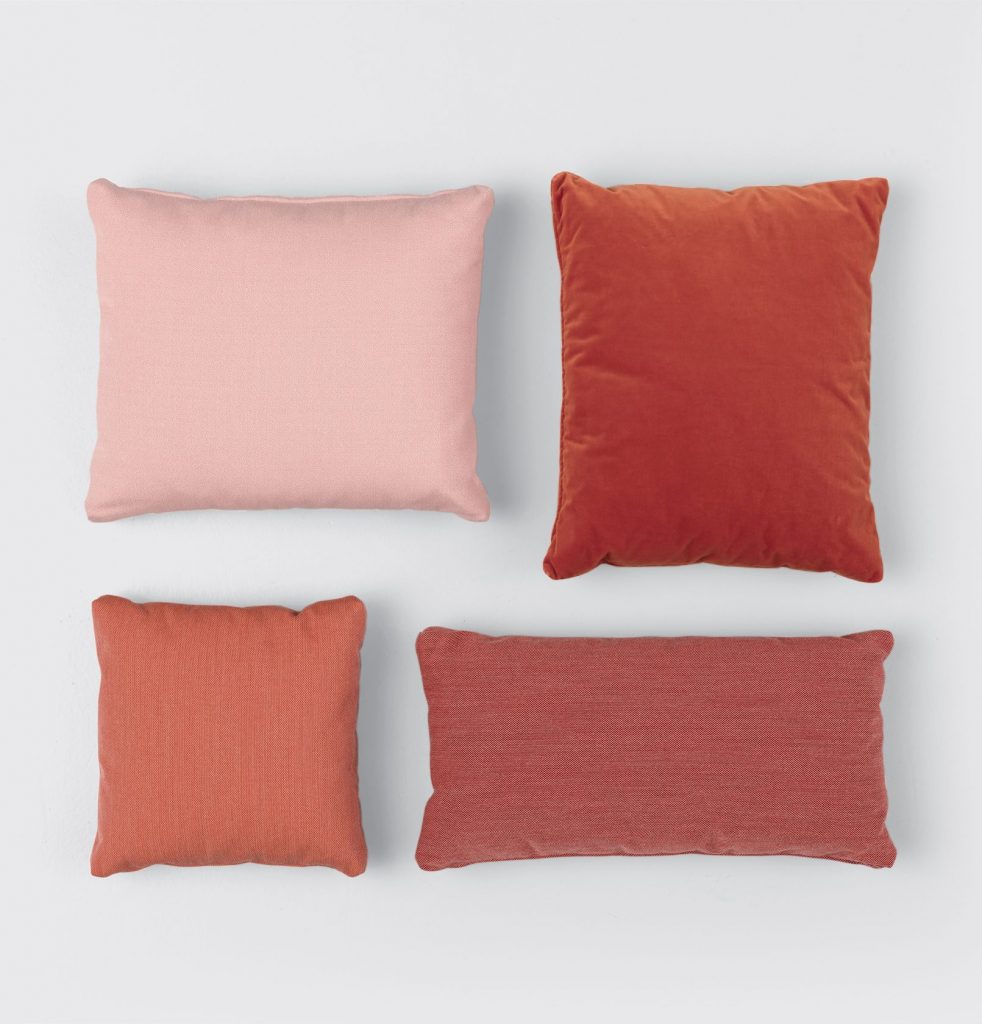 four cushions made in the shape of a square with a goose feather base in a salmon color in different shades