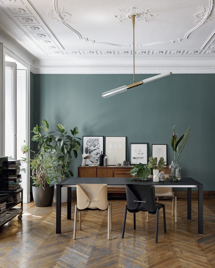 dining table made of black wooden top and aluminum legs on a kitchen