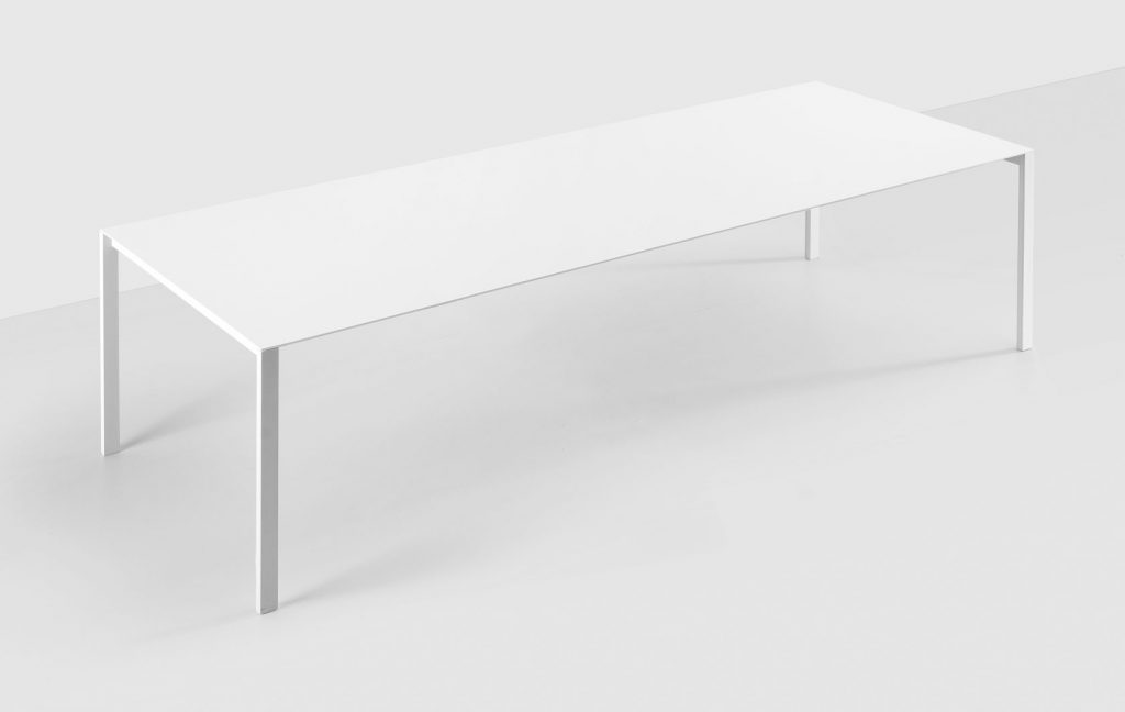 Rectangular-shaped table made with a base of metal legs and aluminum top in a white tone