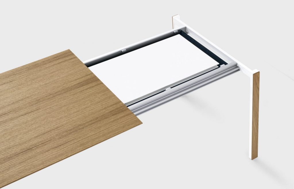 extendable table made of metal and aluminum in a white tone with coffee on a white background