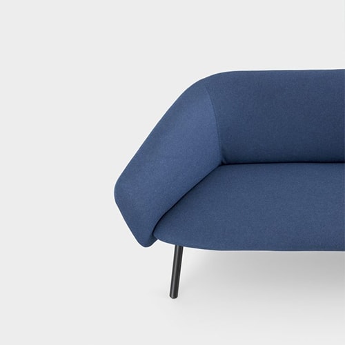 sofa made with wooden legs and covered in dark blue fabric on a white background