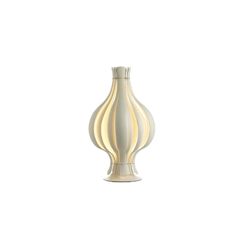 Metal table lamp in white and golden finishies on a white background