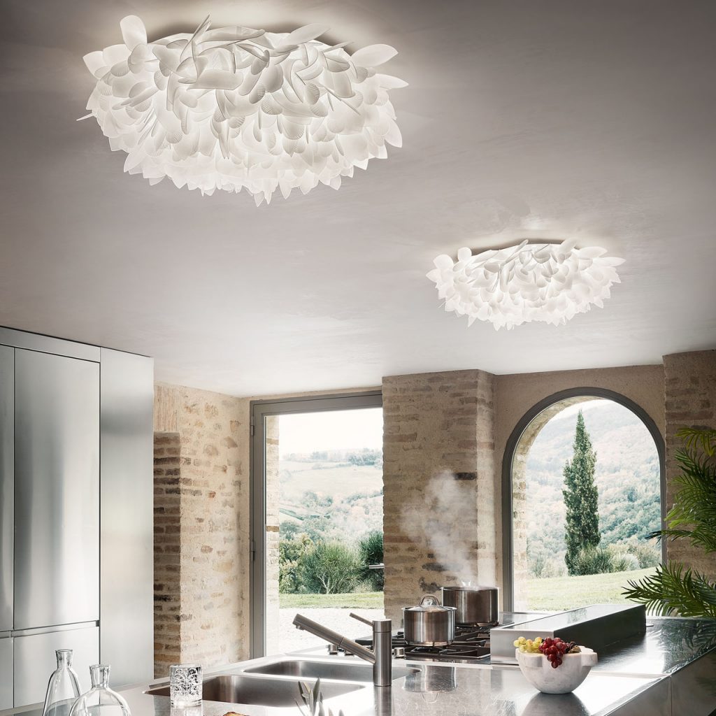 two lamps made of natural flower-shaped pieces opening into several petals in a white tone