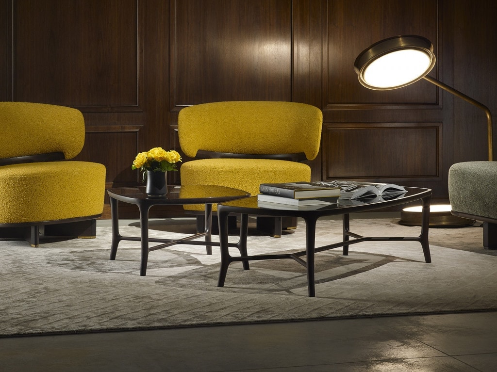 two coffee tables made of wood and cirstal tops in shades of brown and black in a living room