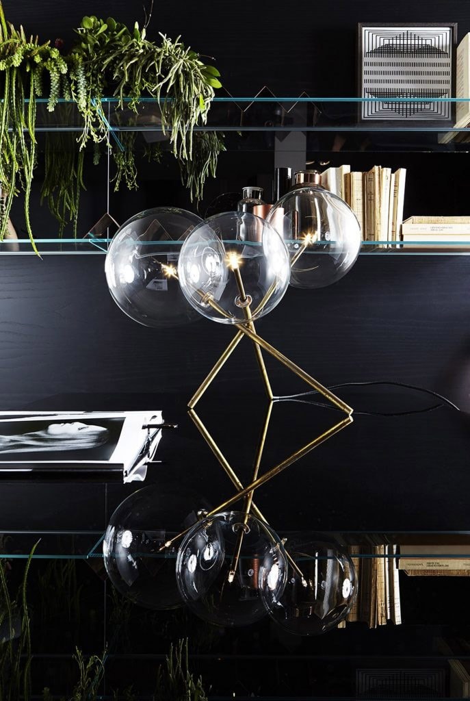 table lamp made of three white blown glass spheres and burnt brass base