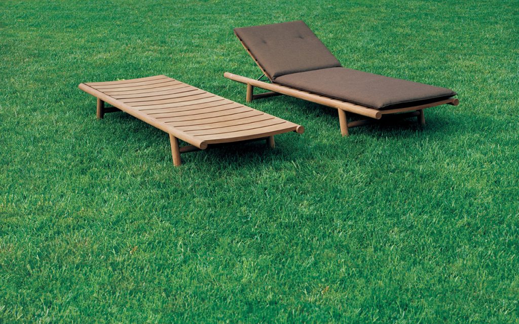 two lounge chairs made of teak base with openings in their structure on a pastel