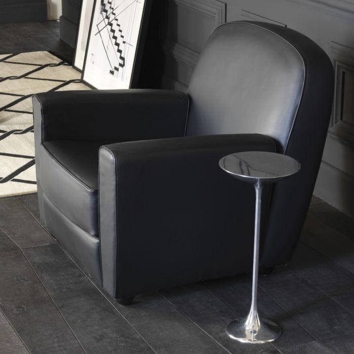 Small metal side table finished in a silver tone with black finishes on a living room
