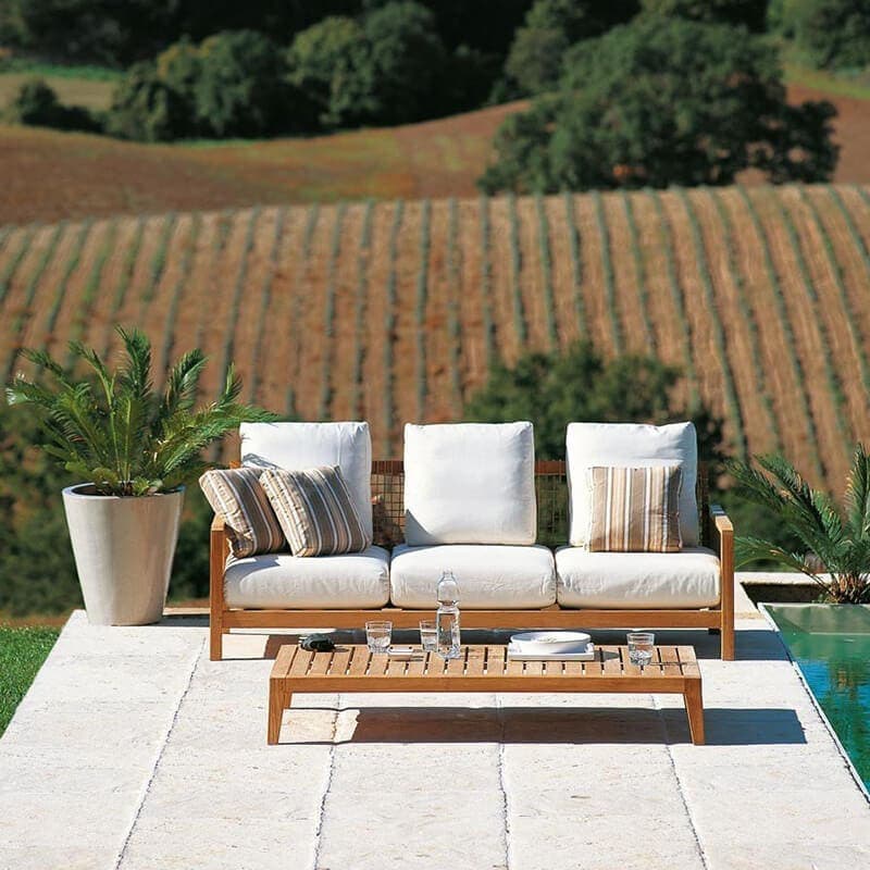 Outdoor coffee table made of teak wood in a brown tone with openings in its structure